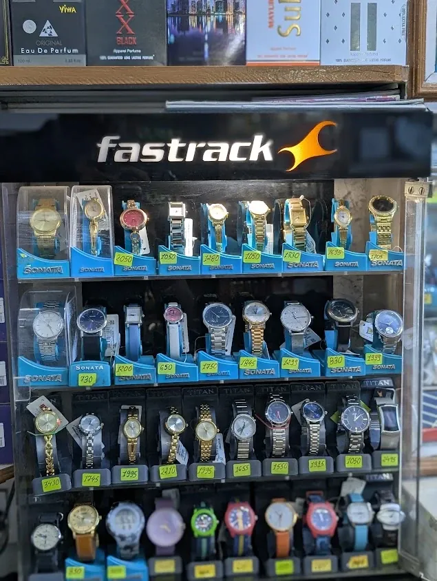 Titan and Sonata watches for men and women on display with price tags at Jay Santoshi Watch, Ahmedabad